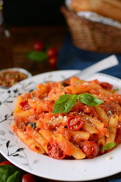 a white plate topped with pasta covered in sauce