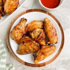 chicken wings on a plate with dipping sauce