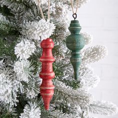 two wooden ornaments hanging from a christmas tree