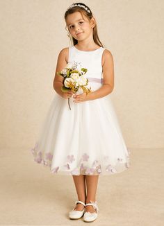 Dot features a charming A-line design crafted from a delightful mix of matte satin and tulle. Its scoop neckline and sleeveless style are complemented by a convenient zipper closure and whimsical bows, creating a playful yet elegant look for any special event. Sleeveless First Communion Dress With Fitted Bodice, White Sleeveless First Communion Dress With Tulle Skirt, Sleeveless Tulle Princess Dress For Confirmation, Sleeveless Tulle Dress For First Communion, Sleeveless Tulle Skirt Dress For First Communion, White Floral Applique Princess Dress For Bridesmaids, White Floral Applique Bridesmaid Princess Dress, White Princess Dress With Floral Applique For Bridesmaids, Sleeveless Tulle First Communion Dress With Floral Applique