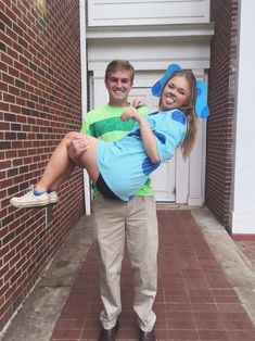 a man carrying a woman on his back in front of a brick wall and door