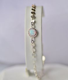 A sweet new bracelet made using a white lab created opal gemstone and sterling silver chain. The chain is made with 4mm discs that are connected with small links. The center of the bracelet features a single, 8mm round lab created opal set into a sterling silver crown edge setting. Bracelet closes with a sterling silver lobster clasp. Please choose desired length at checkout. Dainty and very on trend, perfect for any opal lover! ALSO available in gold or rose gold - please contact me for details Adjustable Opal Round Bracelets, Adjustable Round Opal Bracelets, Silver Opal Bracelet Gift, Adjustable White Opal Jewelry, Opal Bracelet Silver, October Gifts, Chain Layering, Disc Bracelet, White Lab