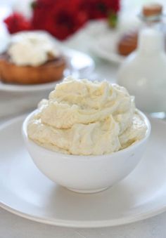 a white bowl filled with mashed potatoes on top of a plate