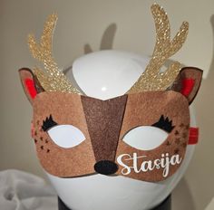 a white vase with a brown and gold mask on it's head that says starga