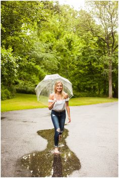 a woman walking in the rain with an umbrella