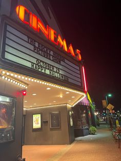 the marquee for cinema's theater is lit up at night