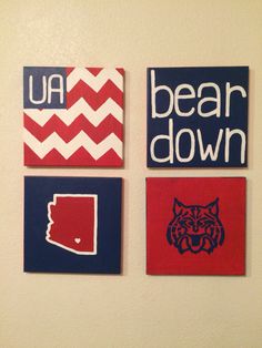 three red, white and blue wall hangings with the words bear down on them