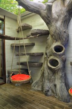 a tree stump with two hanging baskets on it's sides and a red cushion in the middle