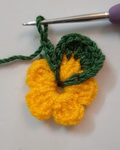 the crochet flower is being worked on