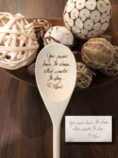 a spoon with some writing on it sitting on a table next to an egg and mushrooms