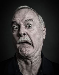 an older man making a face with his eyes wide open