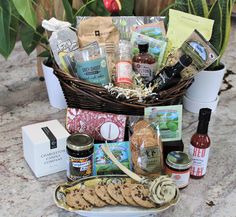 a basket filled with food and condiments sitting on top of a marble counter