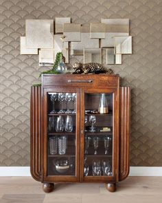 a wooden cabinet with wine glasses on top