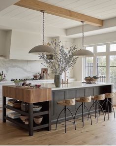 a large kitchen island with stools in front of it