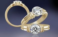 two wedding rings with one diamond on each side and the other in yellow gold, against a blue background