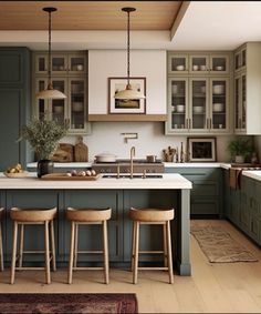 an image of a kitchen setting with green cabinets and stools on the countertop