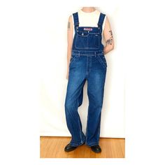 Carpenter-style dark blue denim overalls with pockets at the chest, hip, back + side. Also has belt loops + adjustable straps. In incredible condition. Blue is a bit more muted than the model pics (it's closer to the product photos). Material : 100% cotton Brand : Silver Jeans - made in Canada Tag Size : S / 32 Best Fit : S Era : 90s Condition : excellent Care : machine wash MEASUREMENTS (taken flat) Shoulder Width : 9" Bust / Chest : open Length : 51.5" + straps Strap Length : adjustable Waist Utility Denim Overalls With Belt Loops, 90s Style Denim Overalls With Pockets, 90s Denim Overalls With Pockets, Denim Jumpsuit With Belt Loops In Dark Wash, Dark Wash Full-length Overalls With Pockets, Dark Wash Full Length Overalls With Pockets, Vintage Dark Wash Denim Jumpsuit With Straight Leg, Vintage Dark Wash Straight Leg Denim Jumpsuit, Blue Denim Overalls