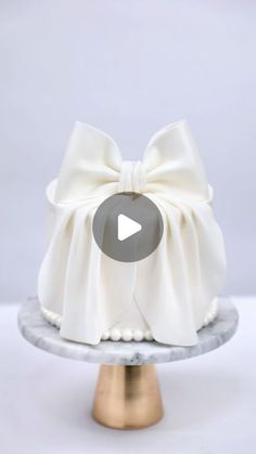 a white cake with a bow on top