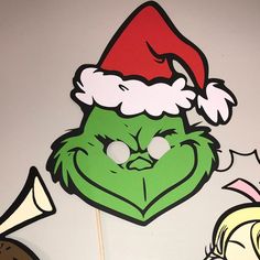 the grin face has been cut out to look like he is wearing a santa hat