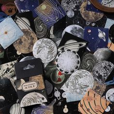 a pile of assorted magnets with space images on them