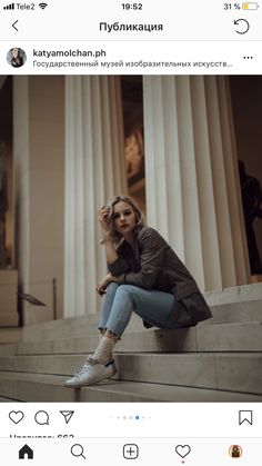 a woman sitting on the steps of a building