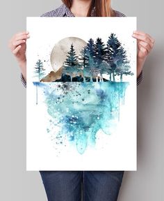 a woman holding up a watercolor painting with trees on the shore and moon in the background