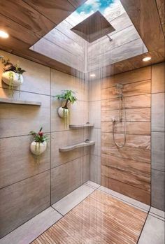 a bathroom with a skylight above the shower and wooden flooring on the walls