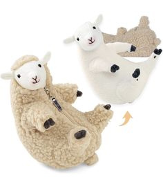 three stuffed animals laying on top of each other in the shape of an elephant, sheep and lamb