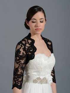 a woman in a white dress and black lace jacket