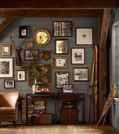 a living room filled with furniture and pictures on the wall next to a wooden floor