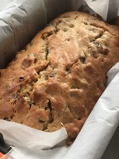 a loaf of bread sitting on top of a piece of white paper in a pan