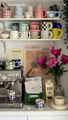 a coffee maker and some cups on a shelf