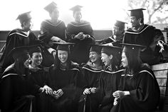 black and white photograph of graduates sitting on steps