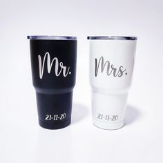 two black and white tumblers with the word mr and mrs on them, sitting next to each other