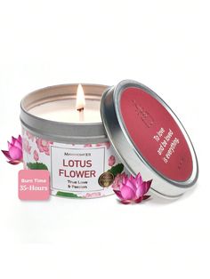 a pink flower candle in a tin next to a small stick of wax on a white background