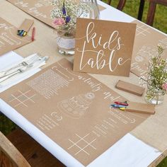 the table is set up with place cards and markers for guests to write their names