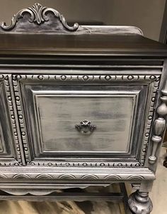 an old dresser has been painted silver