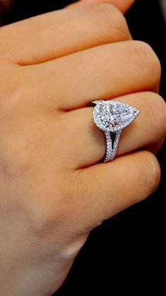 a woman's hand with a diamond ring on it