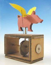 a piggy bank with an arrow sticking out of it's back and wings on top