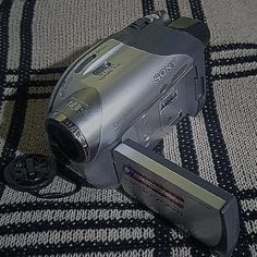 a digital camera sitting on top of a rug