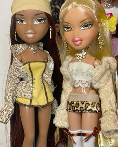 two dolls are standing next to each other