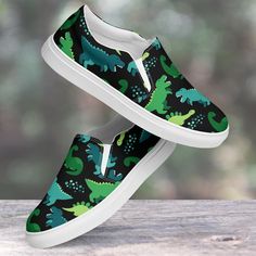 Get ready to stomp in style with these dinosaur design shoes! 🦖👟 Featuring playful dinosaur prints in vibrant colors, these kicks are perfect for bringing out your inner paleontologist. With a sturdy, comfortable build, they're ready for any adventure--whether it's a trek through the park or a day at school. Ideal for dino enthusiasts of all ages, these shoes are a roaring hit! Ready to walk with the dinos? 🦕👣 Made for comfort and ease, these Women's Slip-On Canvas Shoes are stylish and the ideal piece for completing an outfit. Equipped with removable soft insoles and rubber outsoles, it's also easy to adjust them for a better fit. Breathable polyester canvas with PU leather decoration Hi-poly deodorant memory foam insoles EVA shock-absorbing insole Durable rubber outsole Full wraparou Dinosaur Shoes, Dinosaur Prints, Leather Decor, Design Shoes, Dinosaur Design, Dinosaur Print, Shoes Trainers, At School, Shoes For Women