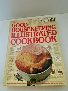 the good house keeping illustrated cookbook is on top of a white table with an image of a pot pie in it