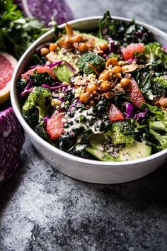 a salad with broccoli, radishes and nuts in a white bowl