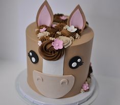 a cake decorated with flowers and an animal's head