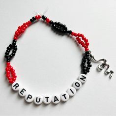 a beaded bracelet with the word repuptation written in white and black beads