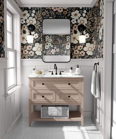 a bathroom with floral wallpaper and two sinks under a large mirror above the sink