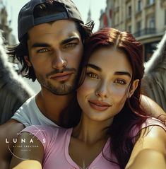 a man and woman posing for a photo in front of an angel's wing