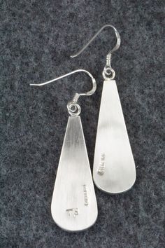 These sterling silver earrings are made by Hopi silversmith Timothy Mowa. The backs are signed and stamped sterling.Length: 1 7/8"Width: 1/2"Free shipping on all orders! We ship with USPS and always include tracking. All orders ship within a day of payment.Returns are accepted up to 30 days after you receive your order. Just send us a message. Our shop offers cash back or store credit. The item must be returned in new condition. Engraved Teardrop Sterling Silver Earrings, Silver Engraved Teardrop Earrings, Engraved Sterling Silver Dangle Earrings, Collectible Sterling Silver Drop Earrings, Sterling Silver Long Drop Jewelry With Polished Finish, Nickel-free Sterling Silver Collectible Earrings, Silver Pieces, Native American Jewelry, Free Jewelry