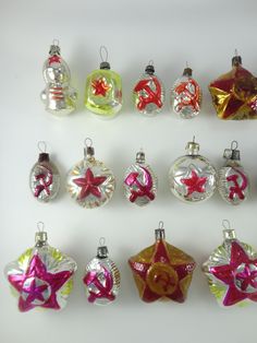 twelve christmas ornaments are arranged on a white surface